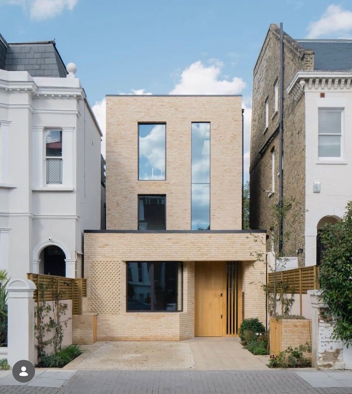 Completed bespoke contemporary family home featuring architectural brick detailing, large-format glazing and landscaped frontage