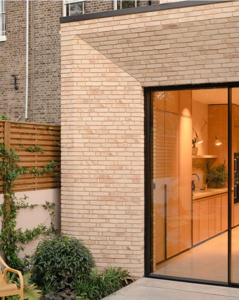 Contemporary kitchen extension with bespoke brick detailing and large sliding glass doors at the Wandle Road project in Wandsworth SW17
